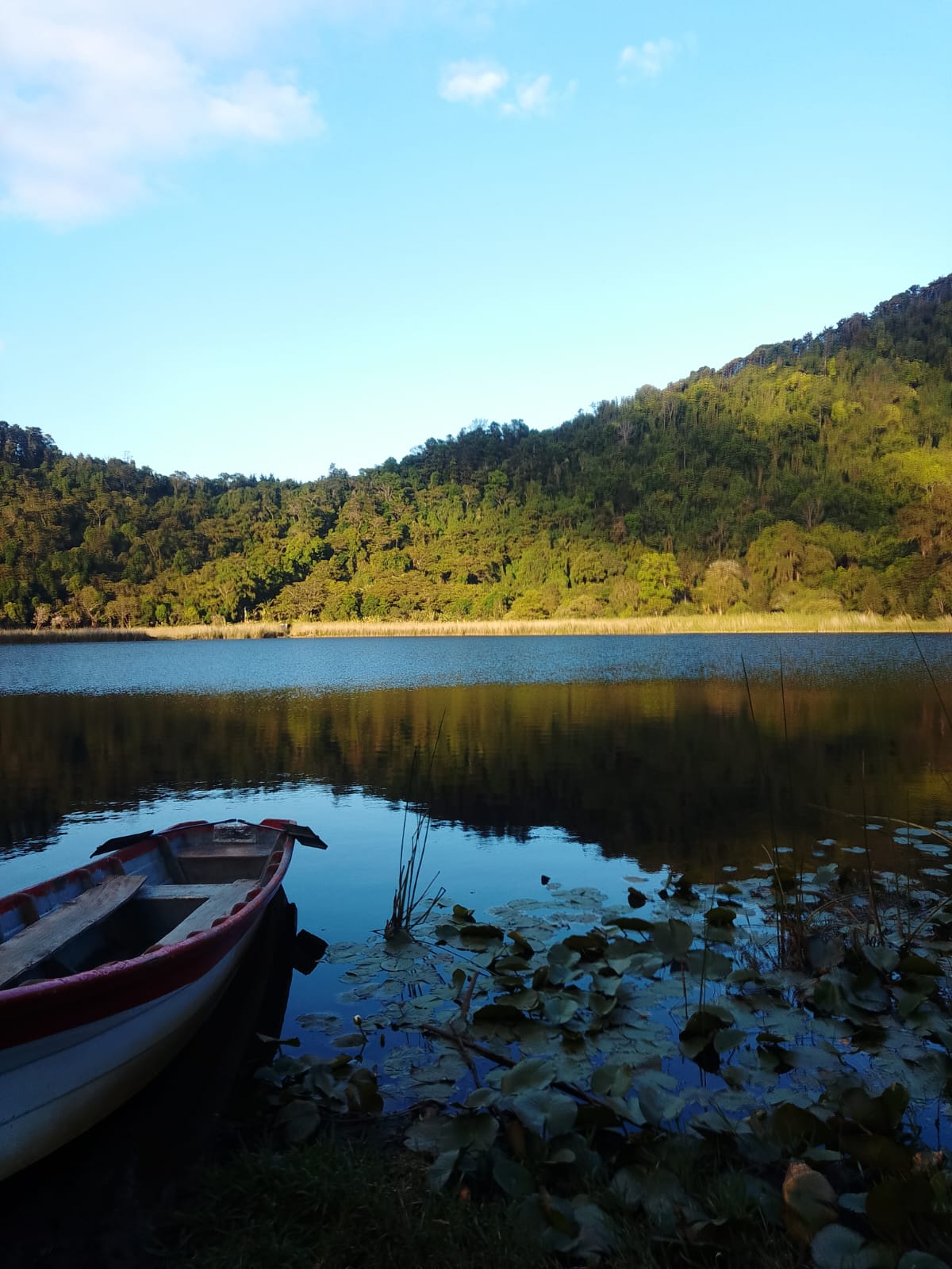 Alegría crater lagoon with wooden boat